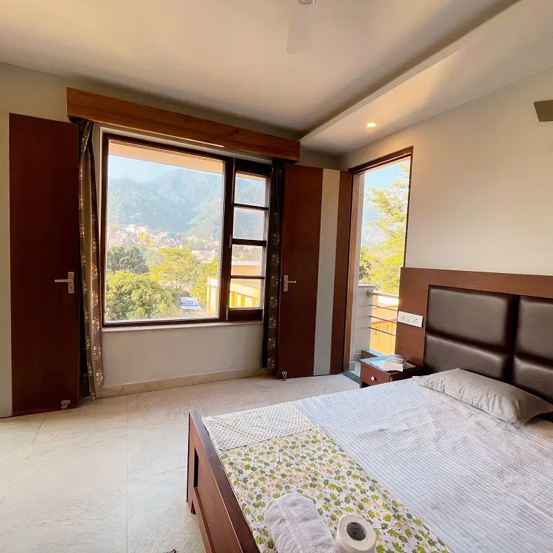 Private retreat room with a double bed and Himalayan mountain view in Rishikesh