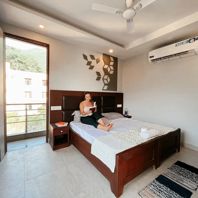 Guest reading in an air-conditioned room with private balcony